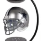 A silver football helmet with a star logo is suspended magnetically between two black stands.