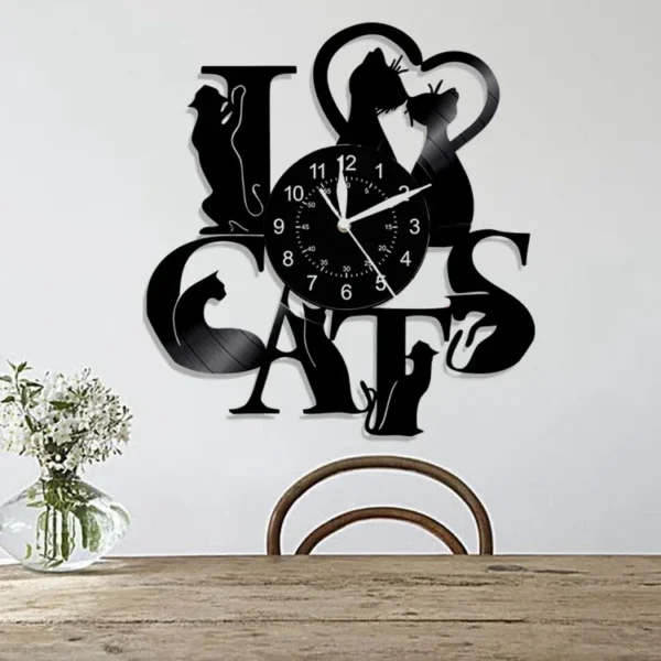 Cute Cat Wall Clock Cute Little Cat Vinyl Record Animal Wall Clock Cat Lover Gift Children’s Room Decorative Art Wall Clock 2 Wall clock designed with the phrase "I love cats" incorporating cat silhouettes, mounted above a wooden chair and table with a small vase of flowers.