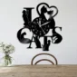 Wall clock designed with the phrase "I love cats" incorporating cat silhouettes, mounted above a wooden chair and table with a small vase of flowers.
