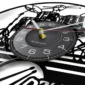 Close-up of a clock designed to look like a vinyl record, featuring a black dial with white numbers and drum set illustration in the background.