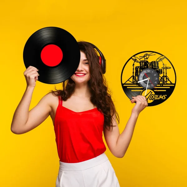 Drummers Personalized Drum Wall Clock Music Instrument Drum Kit Wall Decor Vinyl Record Wall Clock Music Lover Drummers Gift 5 Smiling woman in a red top holds a vinyl record and a drum-themed clock against a yellow background, wearing headphones.