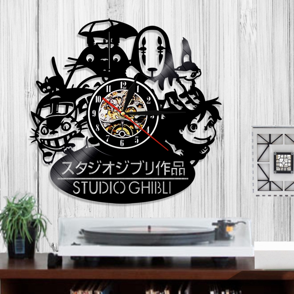 Introducing the Totoro Studio Ghibli Wall Clock, artfully crafted from a vinyl record. This charming piece features cutouts of beloved Studio Ghibli characters and is designed to be mounted above a turntable on a wooden wall. The black Totoro clock serves as both an enchanting and functional decor addition.