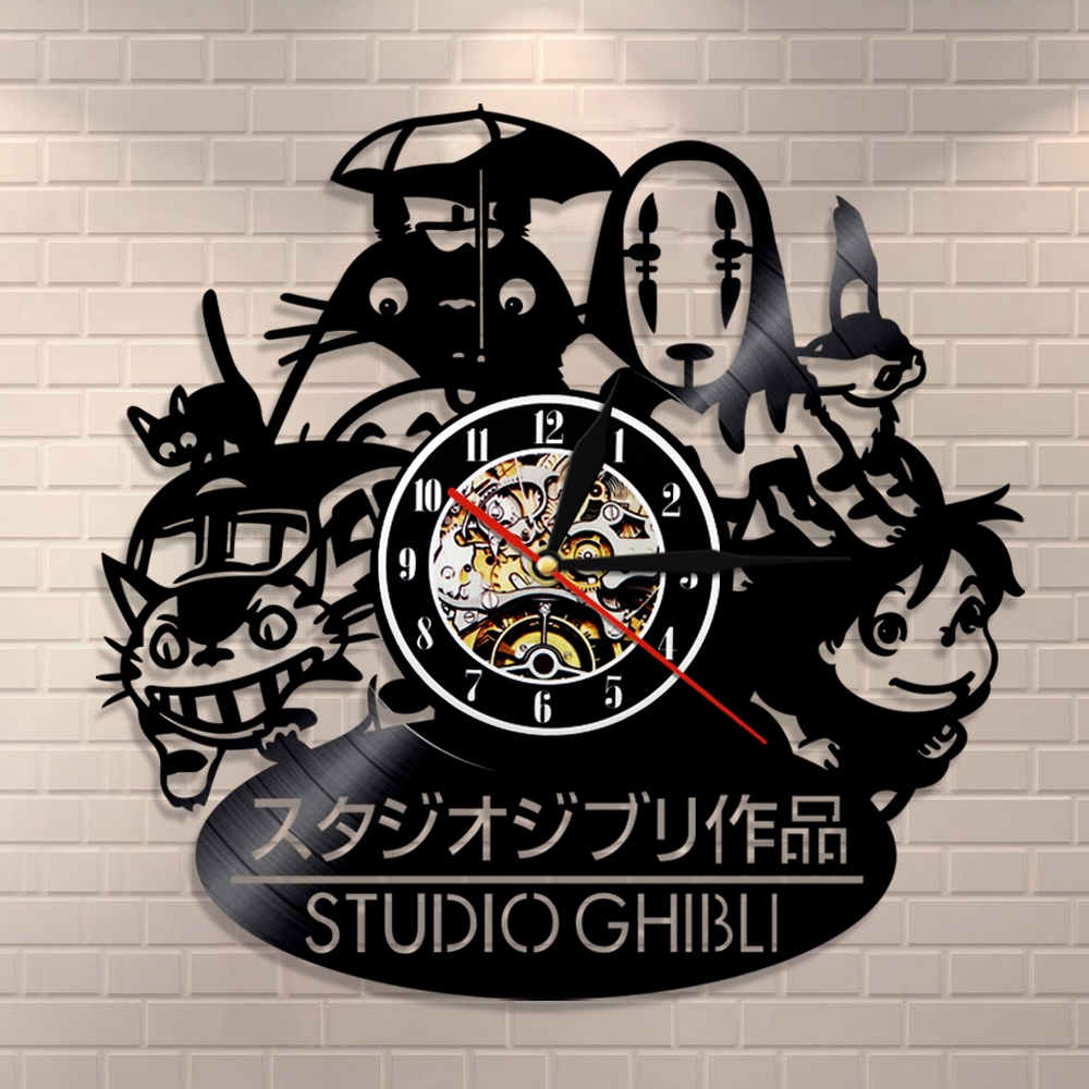 Introducing the Totoro Studio Ghibli Wall Clock, a captivating wall piece adorned with cherished Studio Ghibli characters. Its intricate gears form the clock face against a sleek white brick background, adding charm and whimsy to your space with its beautiful illumination.