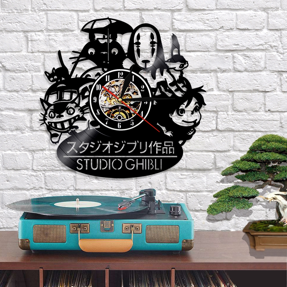 A whimsical touch is added to your space with a Totoro Studio Ghibli Wall Clock featuring beloved characters, complementing a turquoise record player and a small bonsai tree on the table.