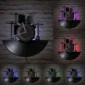 Wall-mounted clock with a vinyl record design, featuring drum kit silhouettes and changing LED lights in red, purple, blue, and green, set against a brick wall.