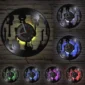 Clock with guitar-shaped cutouts, displayed in six variations, each with different colored LED backlighting against a brick wall.