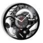 Black wall clock with a music-themed design, featuring notes, headphones, a drum, and a guitar silhouette.