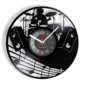 A wall clock featuring a drummer silhouette and musical notes on a vinyl record design.