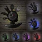 Wall clock with musical instrument designs and neon lights in multiple colors on a brick wall background.