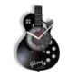Wall clock shaped like an electric guitar with a vinyl record design, featuring clock hands over the guitar's body.