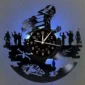 Wall clock with sci-fi themed silhouettes, including spaceships and characters, illuminated by blue light.
