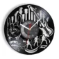A wall clock made from a vinyl record features designs of guitars, musicians, and a hand making a rock gesture.