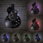 Guitar-shaped wall clock with LED lights in various colors (red, green, blue, purple) displayed on a brick wall.