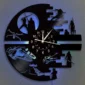 A wall clock with silhouettes of sci-fi characters and scenes, set against a glowing blue background. The clock hands point at various times.