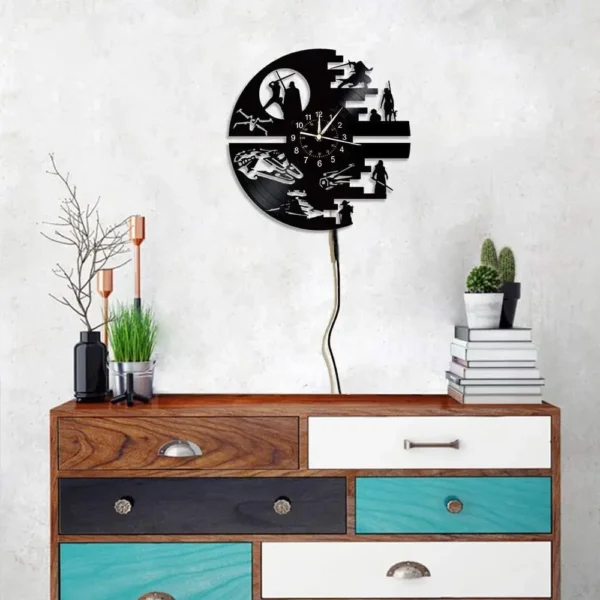 Science Fiction Movie Theme Clock Vinyl Record Wall Clock LED Night Light Home Decoration 7 Color Nightlight Wall Clock Boy Gift 3 Wall-mounted sci-fi-themed clock above a colorful chest of drawers, with stacked books, cacti, and candle holders.