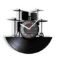 A wall clock designed like a vinyl record with drum set silhouettes, featuring black and white hands and numbers.