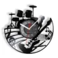 A wall clock features musical instrument silhouettes, including drums, a microphone, a guitar, and musical notes, on a black circular design.