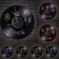 Vinyl record wall clocks with guitar and rock hand designs, displaying various LED light colors on a brick background.