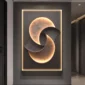 A modern wall art piece featuring abstract, interlocking shapes with illuminated edges, creating a circular pattern.