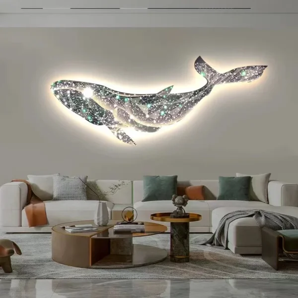 Modern luxury starry sky dream Whale living room sofa Background night light wall decoration bedroom atmosphere lightingPaintin 2 A modern living room with a glowing whale wall art above a beige sofa. Two round coffee tables with various decorative items are in front of the sofa.