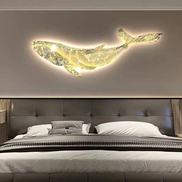 Modern luxury starry sky dream Whale living room sofa Background night light wall decoration bedroom atmosphere lightingPaintin 5 A sleek, modern bedroom features a glowing whale-shaped wall light above a neatly made bed with a gray headboard.