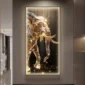 A glowing, golden elephant artwork is illuminated on the wall of a modern, dimly lit hallway.