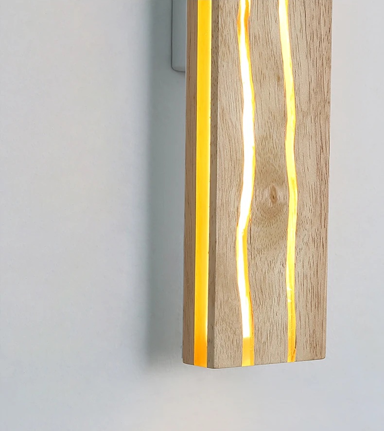 A wooden wall lamp with vertical glowing inlays against a light gray background.