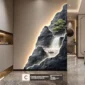 Wall art featuring a waterfall scene, illuminated with a soft glow, depicting boats and trees on rocky terrain. Text overlay at the bottom states: "FLOWING WATER SYMBOLISES CONTINUOUS WEALTH.