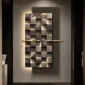 A geometric wall art piece with textured, illuminated square and rectangular patterns, featuring subtle lighting and a modern, minimalist design.