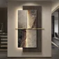 Abstract wall art with textured panels, featuring earth tones and a vertical golden bar dividing the sections. The artwork is illuminated from behind, mounted on a plain wall.
