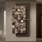 Abstract wall art featuring a textured wooden panel with uneven square patterns, mounted on a dark rectangular background, and intersected by a horizontal gold bar.